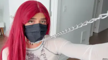 Lily submissively holding her leash up to camera